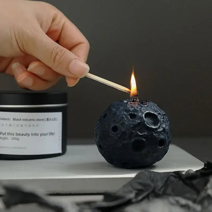 Lighting a geometric meteorite-shaped scented candle with a match